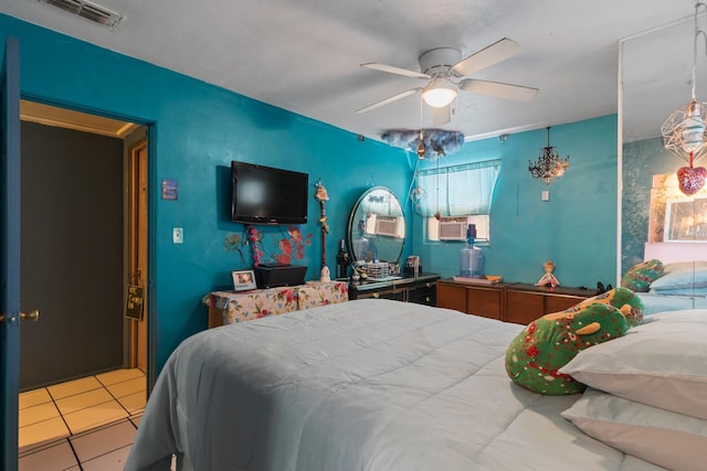 tiled bedroom featuring ceiling fan