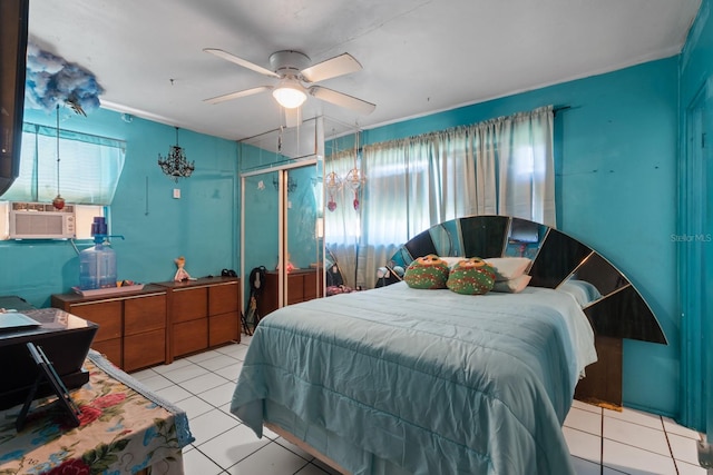 tiled bedroom featuring cooling unit, a closet, and ceiling fan