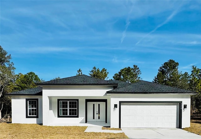 view of front of house with a garage and a front yard