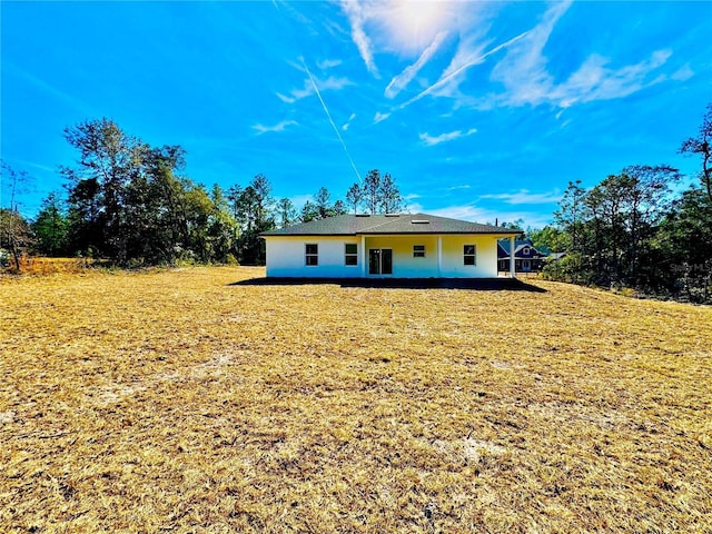 rear view of property with a lawn