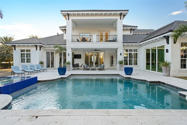 rear view of house featuring a patio, a balcony, and ceiling fan