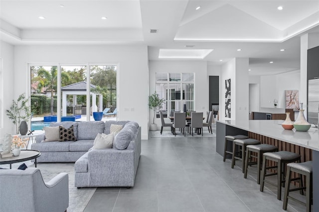 living room with a tray ceiling