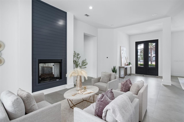 living room with french doors and a multi sided fireplace