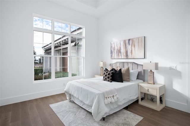 bedroom with dark wood-type flooring