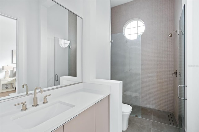 bathroom featuring toilet, vanity, tile patterned floors, and walk in shower