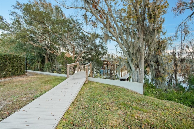 view of home's community featuring a water view and a lawn