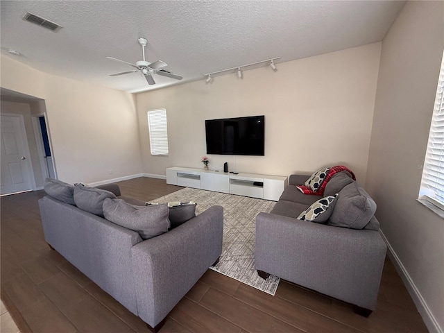 living room featuring a healthy amount of sunlight, track lighting, and a textured ceiling