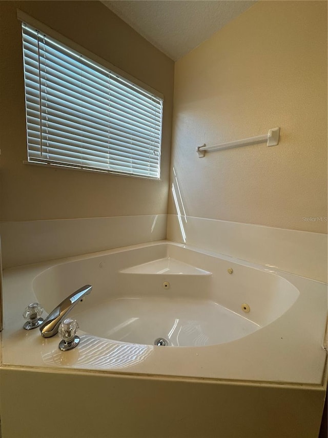 bathroom with a bath and a textured ceiling