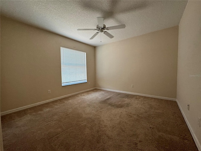 carpeted empty room featuring ceiling fan and a textured ceiling