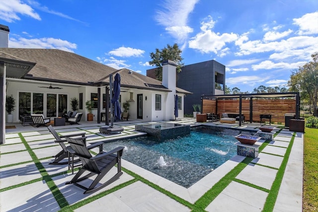 view of pool featuring an in ground hot tub, pool water feature, and a patio area