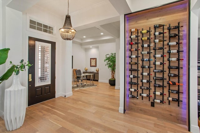 wine area featuring crown molding and hardwood / wood-style flooring