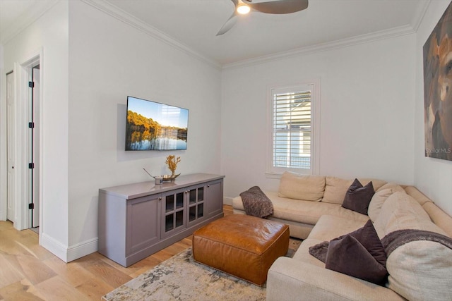 living room featuring crown molding, ceiling fan, and light hardwood / wood-style floors