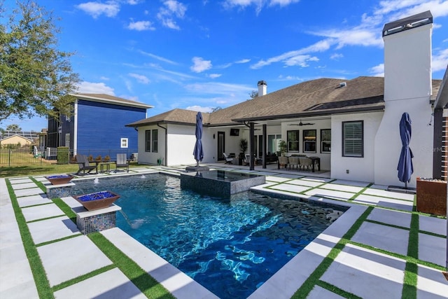 view of swimming pool with a patio area, ceiling fan, and an in ground hot tub