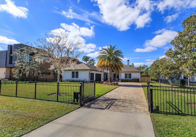 ranch-style home with a garage and a front lawn