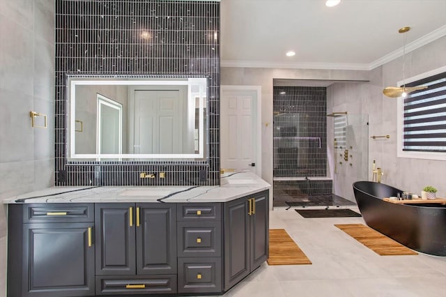 bathroom featuring shower with separate bathtub, tile walls, vanity, crown molding, and tile patterned floors