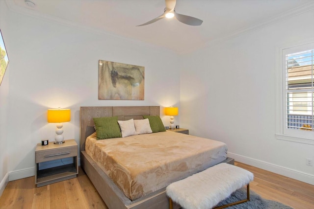 bedroom with crown molding, ceiling fan, and light hardwood / wood-style floors