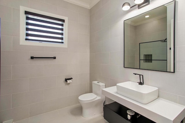 bathroom featuring tile walls, vanity, crown molding, and toilet