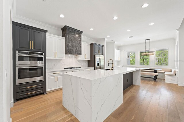 10416 Pocket Ln, Orlando, FL 32836 - kitchen with appliances with stainless steel finishes, a large island, light wood-style floors, recessed lighting, and tasteful backsplash