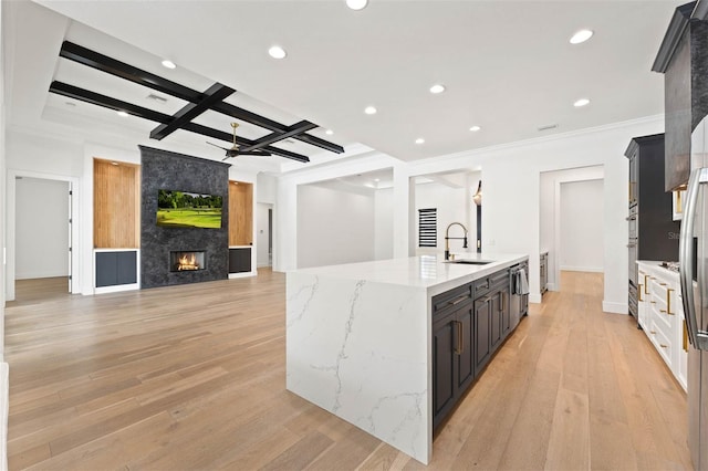 10416 Pocket Ln, Orlando, FL 32836 - kitchen with an island with sink, recessed lighting, open floor plan, light stone countertops, and coffered ceiling