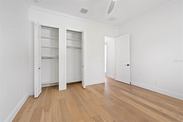 10416 Pocket Ln, Orlando, FL 32836 - unfurnished bedroom with two closets, light wood-style flooring, crown molding, and a ceiling fan
