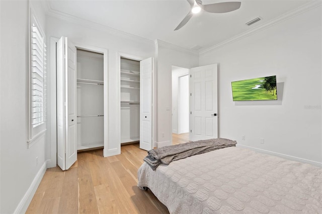 10416 Pocket Ln, Orlando, FL 32836 - bedroom featuring light wood-style floors, multiple closets, crown molding, and a ceiling fan