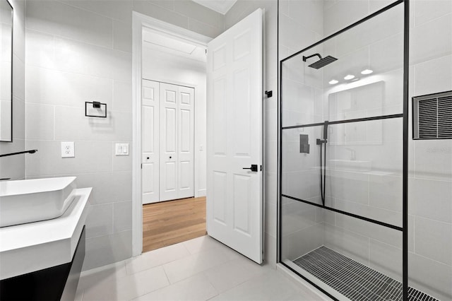 10416 Pocket Ln, Orlando, FL 32836 - full bath with a shower stall, tile patterned flooring, double vanity, tile walls, and a heating unit