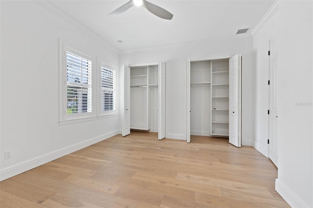 10416 Pocket Ln, Orlando, FL 32836 - unfurnished bedroom with ornamental molding, light wood-style floors, two closets, and a ceiling fan