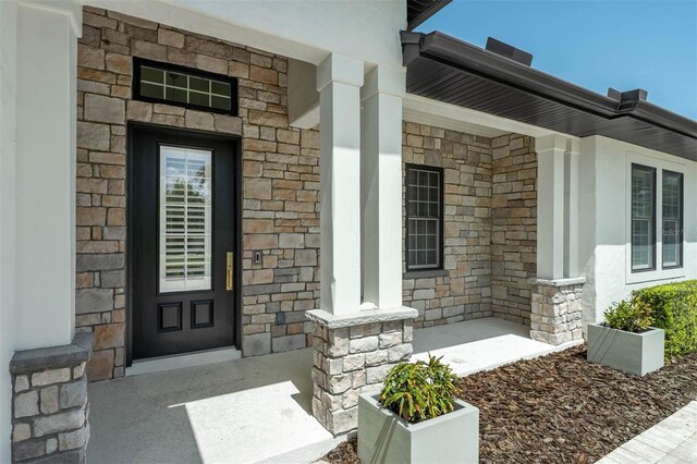 10416 Pocket Ln, Orlando, FL 32836 - view of exterior entry featuring covered porch and stone siding