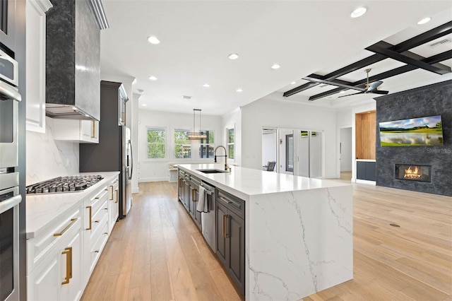 10416 Pocket Ln, Orlando, FL 32836 - kitchen with appliances with stainless steel finishes, light wood-type flooring, recessed lighting, a large island with sink, and open floor plan