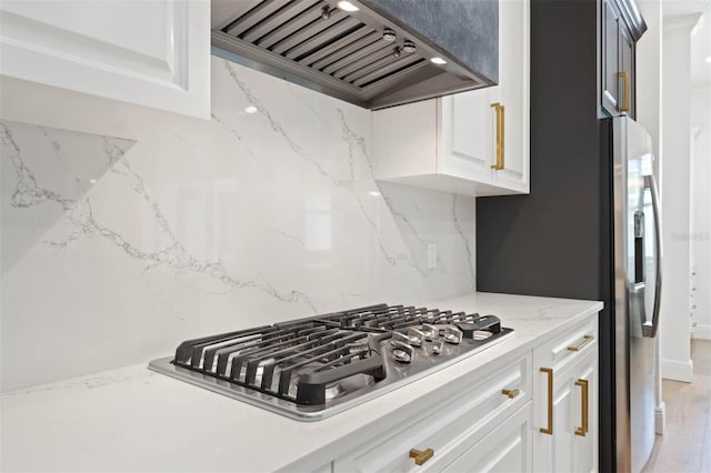 10416 Pocket Ln, Orlando, FL 32836 - kitchen with premium range hood, appliances with stainless steel finishes, tasteful backsplash, light stone countertops, and white cabinets