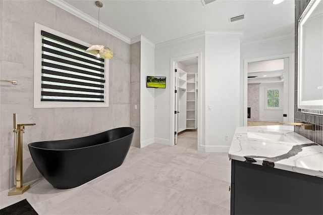 10416 Pocket Ln, Orlando, FL 32836 - full bath with double vanity, a soaking tub, a walk in closet, and ornamental molding