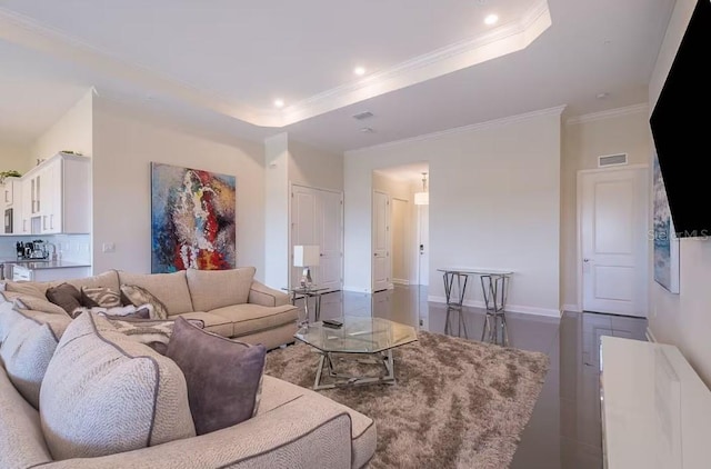 living room featuring dark hardwood / wood-style flooring, ornamental molding, and a raised ceiling