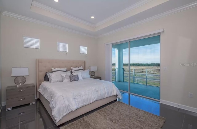 bedroom with crown molding, a tray ceiling, and access to outside