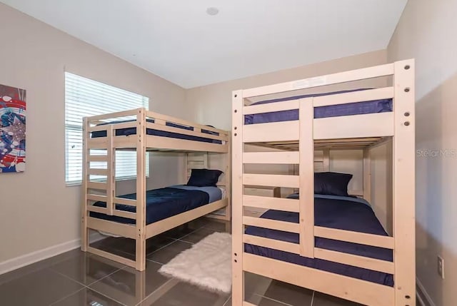 bedroom featuring dark tile patterned flooring