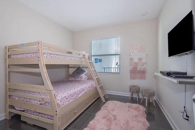 bedroom with dark tile patterned floors