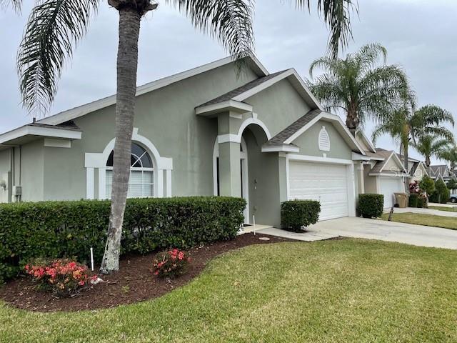 ranch-style house with a garage and a front yard