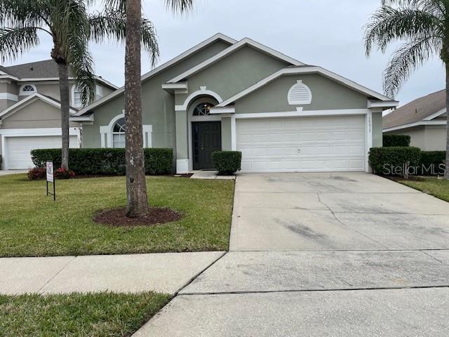 view of front of house with a garage and a front yard