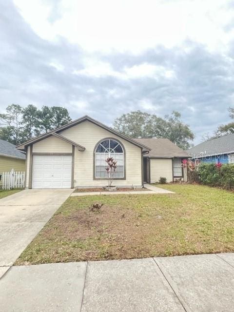 view of front of house with a garage and a front lawn