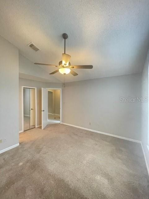 unfurnished room with a textured ceiling, ceiling fan, and carpet flooring