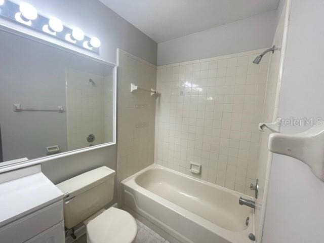 full bathroom featuring vanity, toilet, and tiled shower / bath