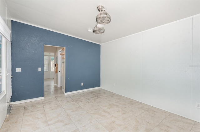 spare room featuring ornamental molding