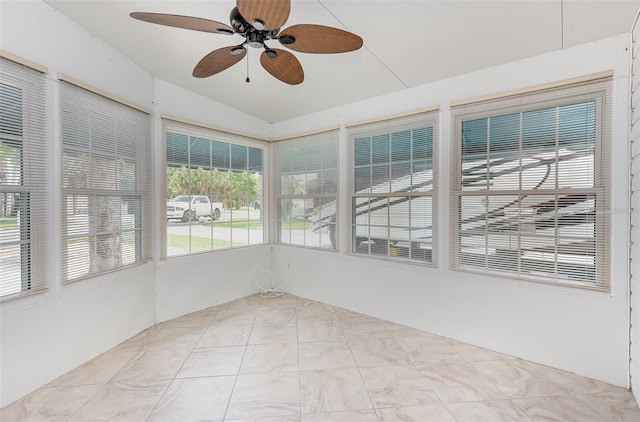 unfurnished sunroom with ceiling fan