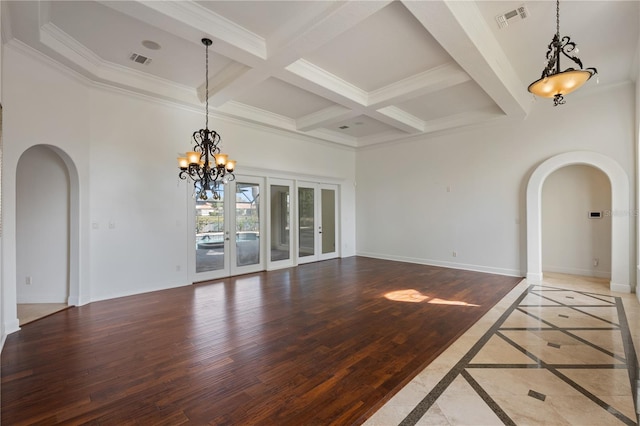 interior space featuring coffered ceiling, a towering ceiling, wood-type flooring, and beamed ceiling