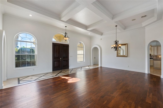 entryway with an inviting chandelier, hardwood / wood-style floors, beam ceiling, coffered ceiling, and ornamental molding