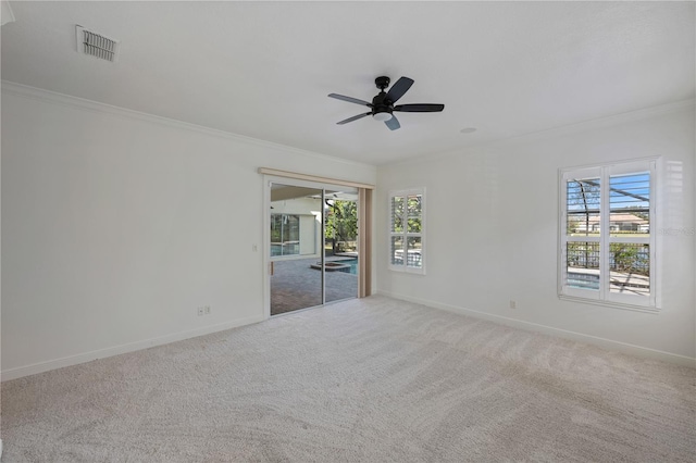 empty room with crown molding, carpet flooring, and ceiling fan