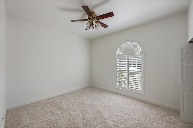 spare room featuring light colored carpet and ceiling fan