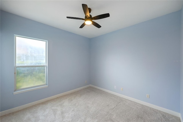 empty room with ceiling fan and carpet flooring