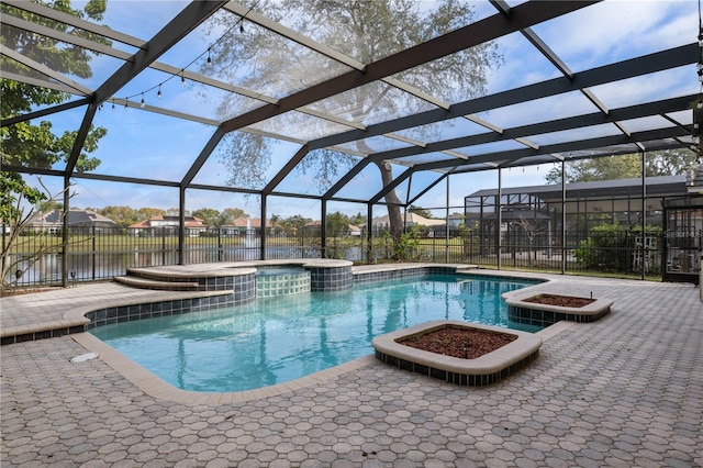 view of swimming pool with a water view, a patio, a lanai, and an in ground hot tub