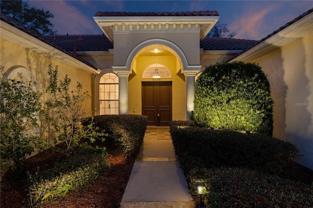 view of exterior entry at dusk