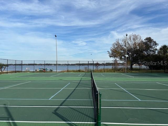 view of sport court with a water view